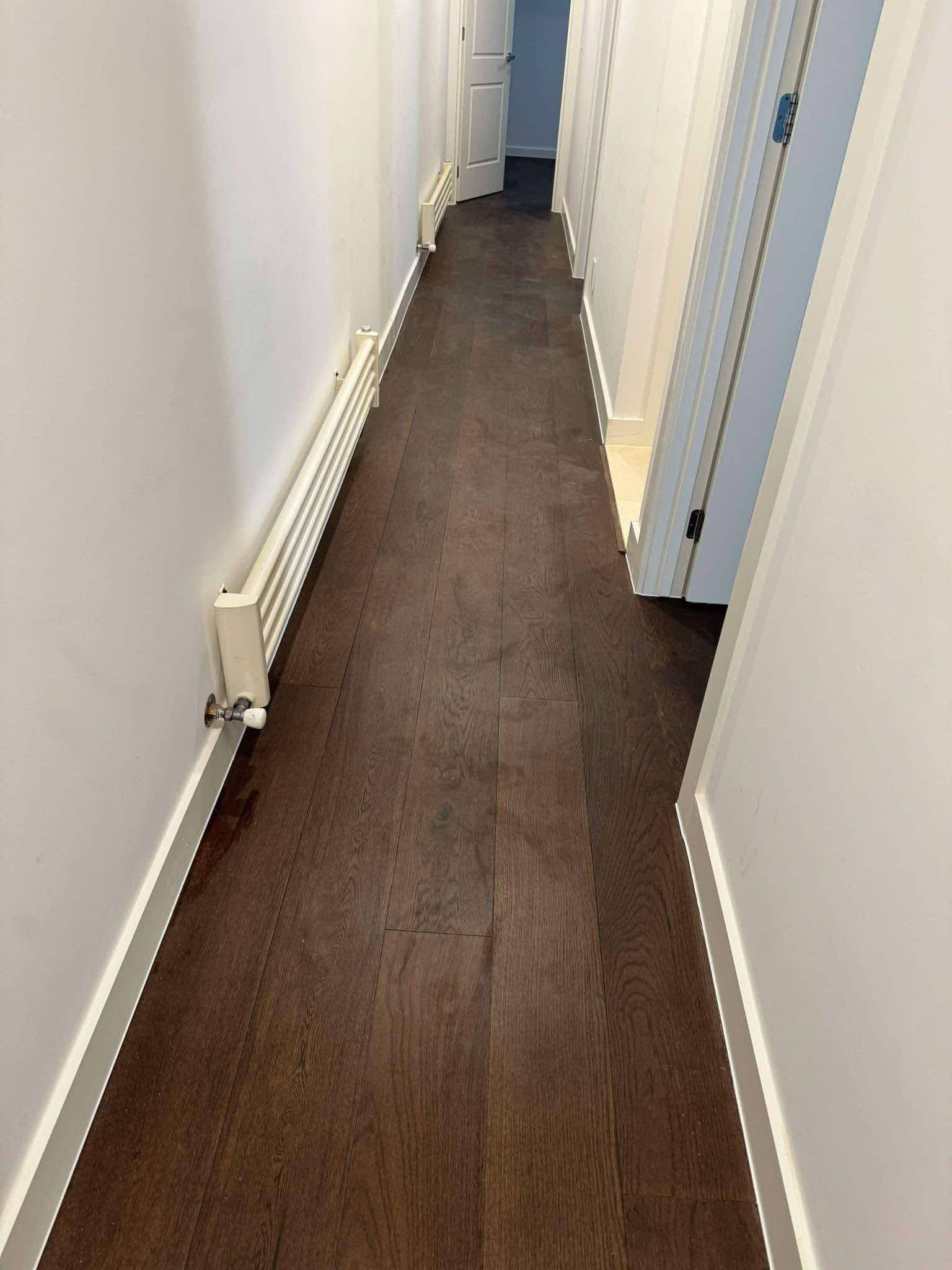 Smoked walnut hybrid plank flooring hallway Melbourne home