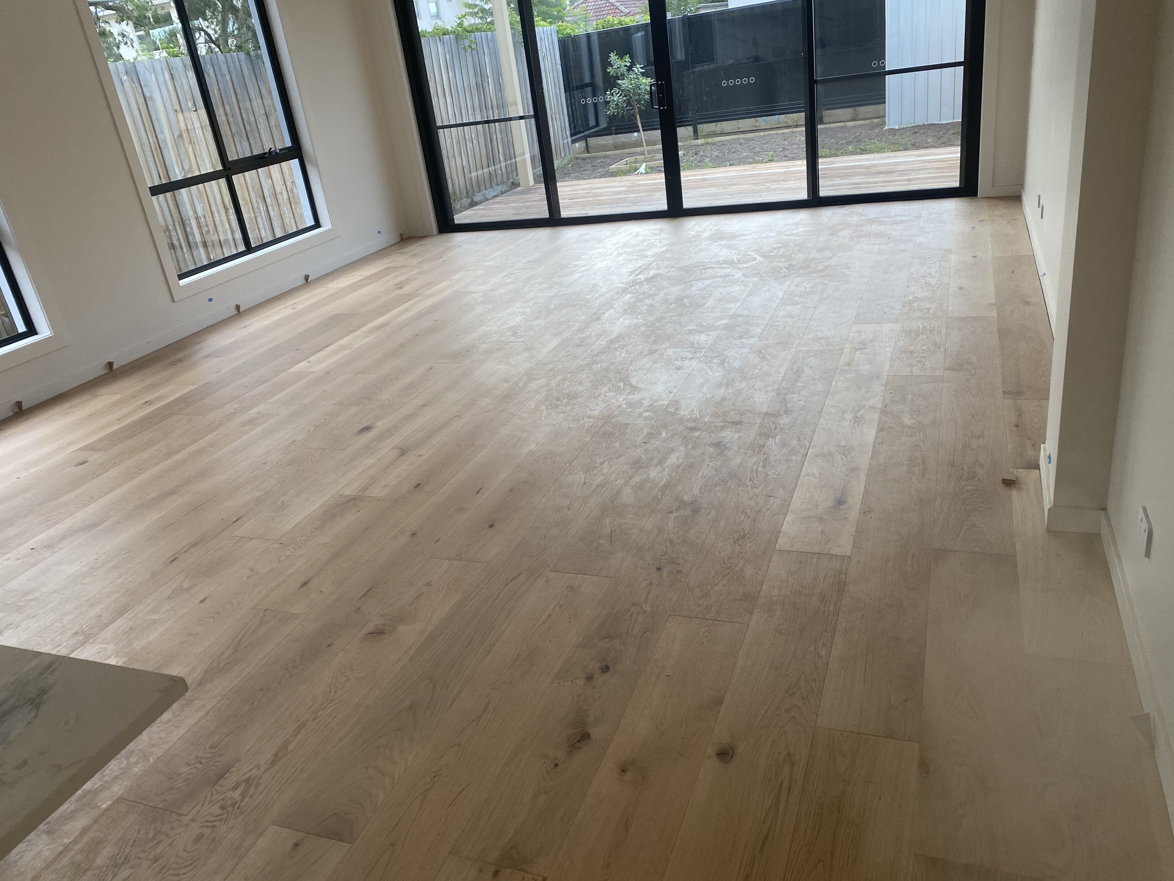 Natural European oak hybrid flooring open plan living room sliders Melbourne