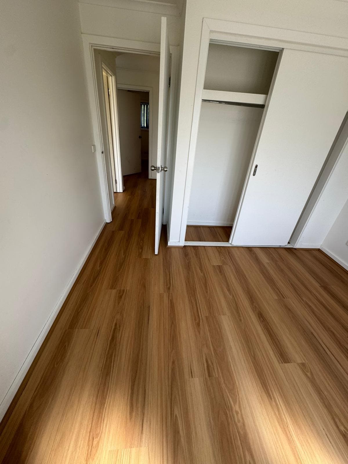 Golden oak hybrid plank flooring bedroom with built-in robes Melbourne