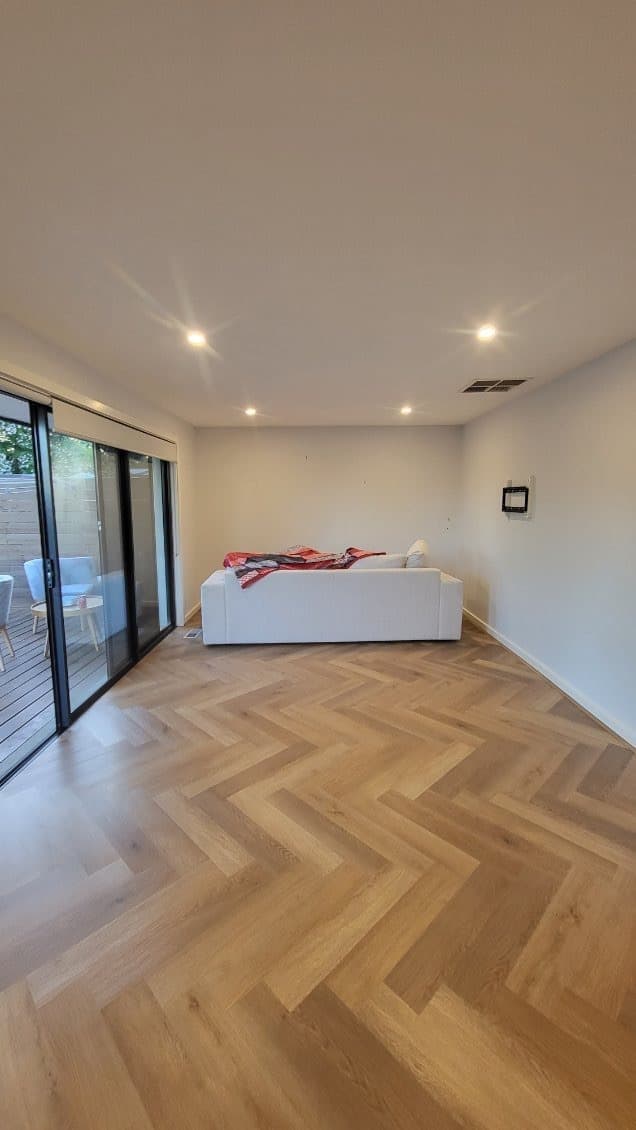 Golden oak herringbone hybrid flooring residential living room Melbourne
